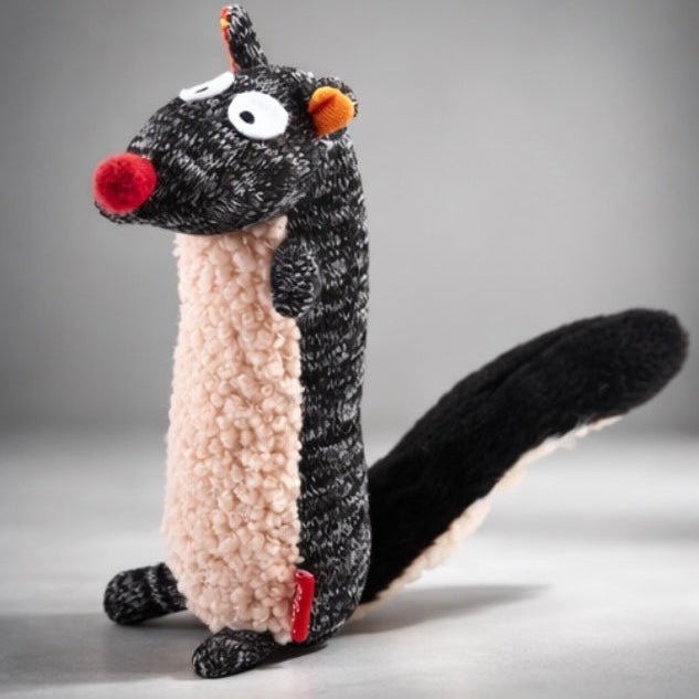 Plush toy resembling a skunk on a gray background